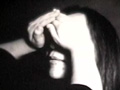 Woman with man's hands over eyes